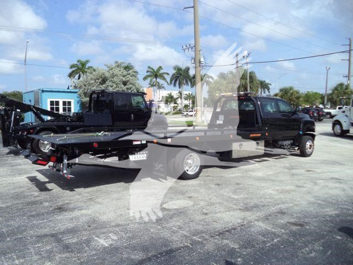 2023 International CV truck in outdoor lot showing rollback bed with towing equipment and dual-wheel group; faint stock watermark.