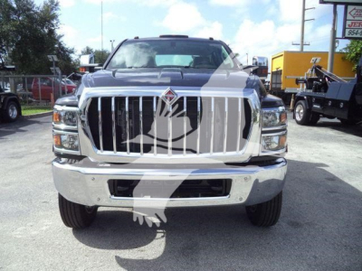 Front view of a 2023 International CV truck with large chrome grille, vertical bars, emblem, and dual headlights.