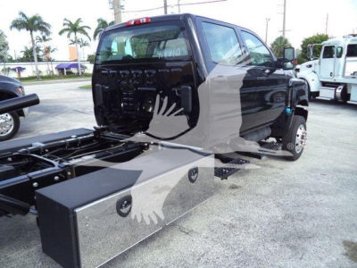 Truck cab of 2023 International Cv rollback chassis showing side-view with storage box and chassis rails.