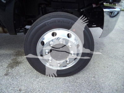 Truck wheel with Conti Hybrid tire and polished steel hub, underbody components visible.