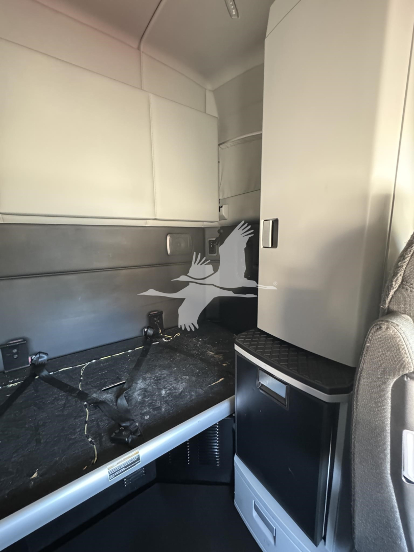 Kenworth T680 truck cab interior with sleeper area, storage cabinet, and counter surface visible.
