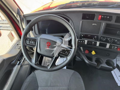 Kenworth T680 truck interior showing steering wheel and dashboard with controls and gauges.
