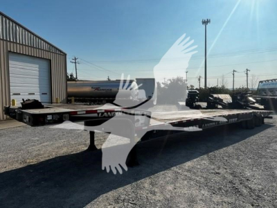 Landoll travel trailer flatbed used trailer showing long steel deck and wheel chocks with a watermark overlay.