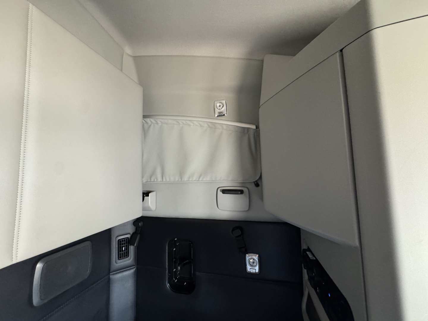 Kenworth T680 sleeper cab interior showing storage compartments and panel in neutral state.