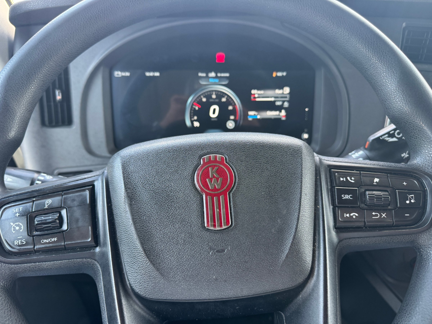 Kenworth T680 interior steering wheel and digital instrument cluster, KW emblem on steering wheel hub