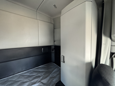 Kenworth T680 sleeper cab interior showing storage cabinet and bed area