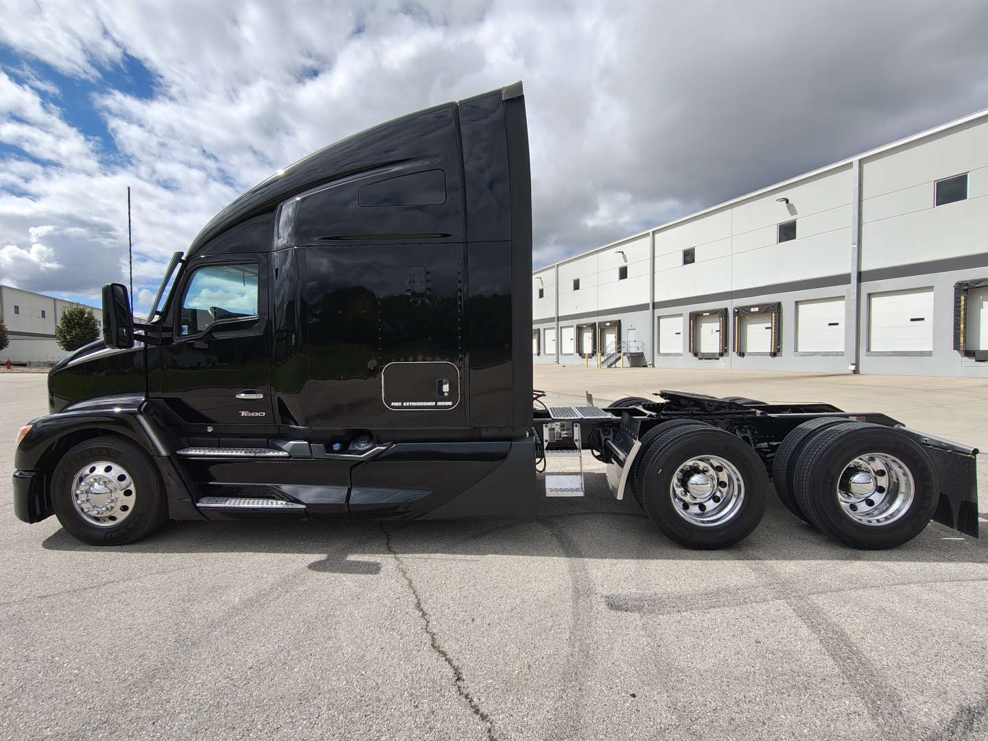 Kenworth T680 conventional sleeper truck side view showing cab and chassis with dual rear axles.