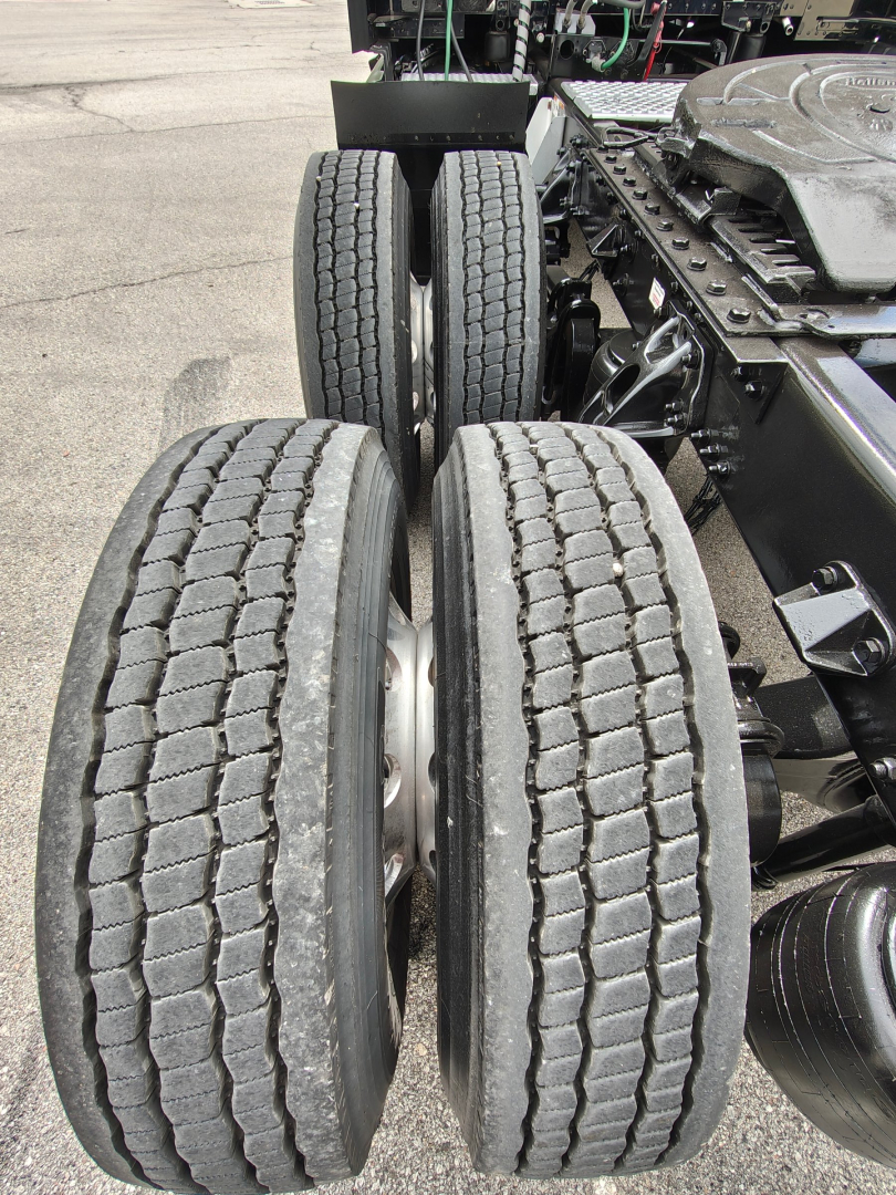 Kenworth T680 chassis showing dual rear axles and tires with visible frame and components.
