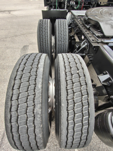 Kenworth T680 chassis showing dual rear axles and tires with visible frame and components.