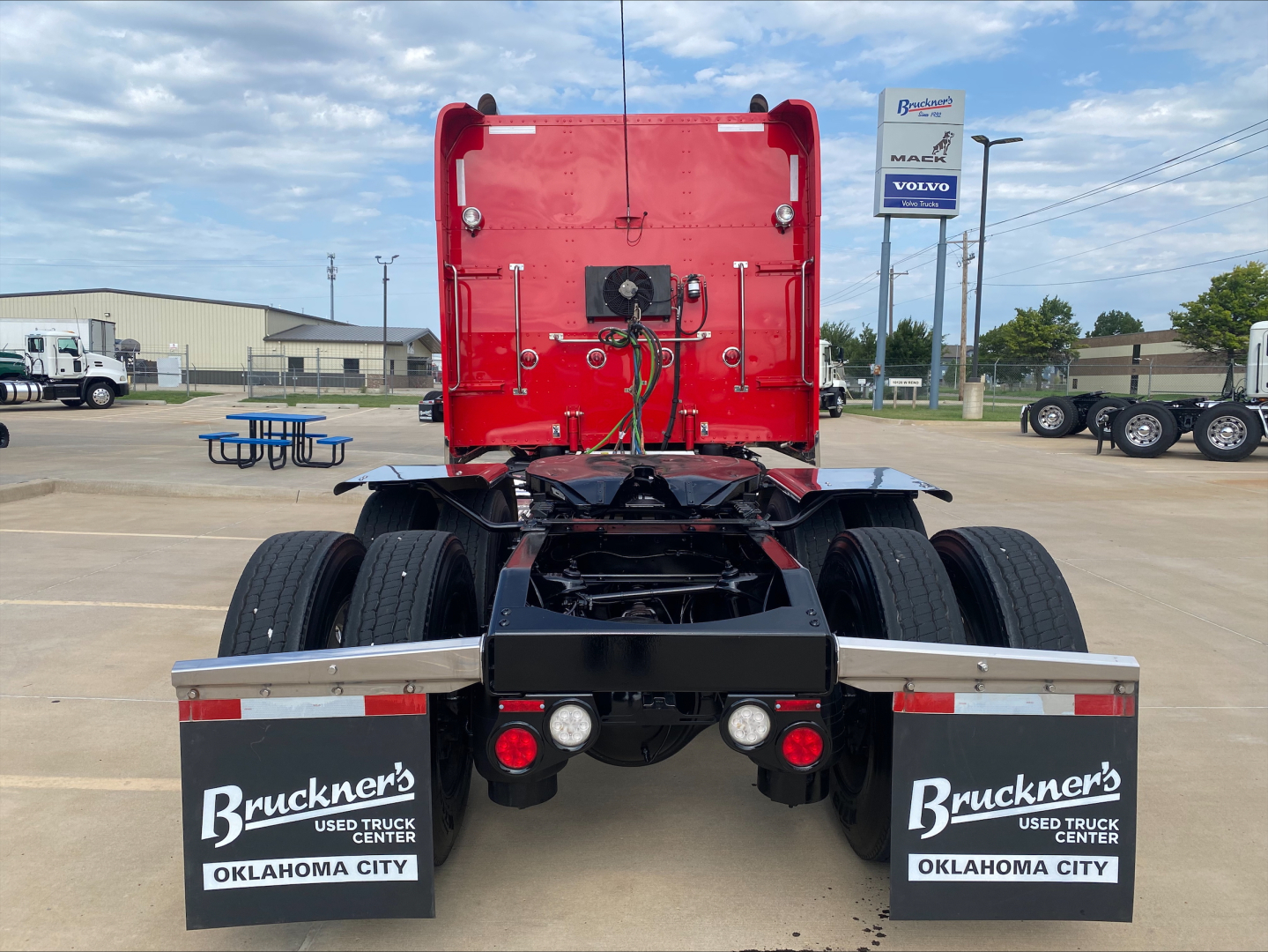Peterbilt 389 rear view showing dual rear axles, fifth wheel and mud flaps with Brunker’s Truck Center Oklahoma City branding.