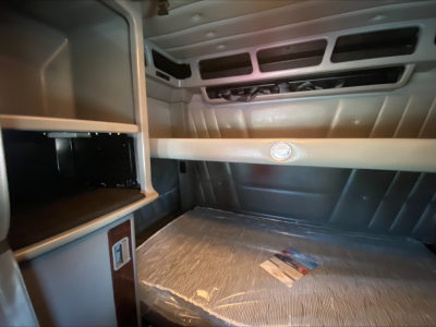 Peterbilt 389 sleeper cab interior/truck cabin storage bunker area with overhead vent slots and bed platform, 2021 model year showroom photo.