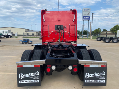 Peterbilt 389 rear view showing dual rear axles, fifth wheel and mud flaps with Brunker’s Truck Center Oklahoma City branding.