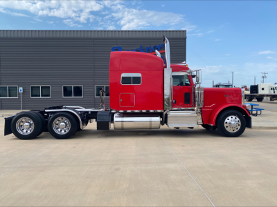 Red Peterbilt 389 conventional sleeper truck side profile showing cab and chassis, with chrome exhaust stacks and fuel tanks.