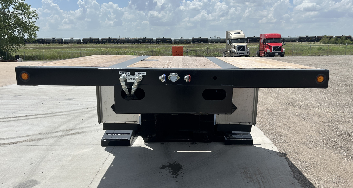 Alpha trailer A70HDGC-M hydraulic detach double drop mini deck showing coupler, air lines, and control valves