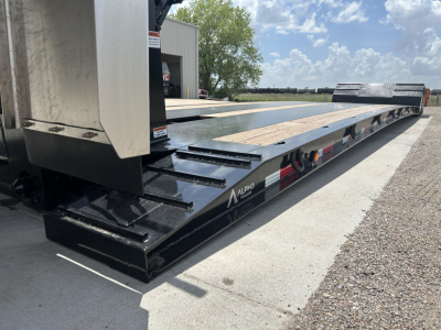 Lowboy trailer with hydraulic detach double drop mini deck showing Alpha logo and metal steps; long flatbed with wooden deck and black frame