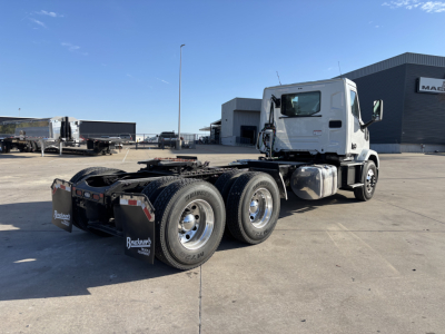 Mack AN64T conventional daycab tractor showing chassis and rear dual axle with fuel tanks and cab in view.