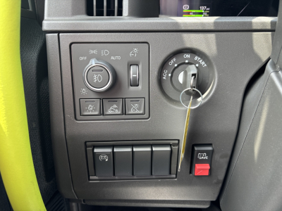 Truck dash area showing headlight control panel and ignition key in Volvo VNL interior.