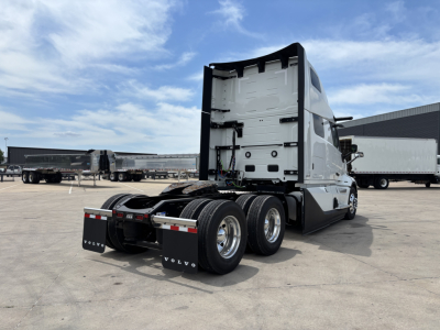 Volvo VNL64T860 tractor rear view showing sleeper cab, rear wheels, and fifth wheel with mud flaps.