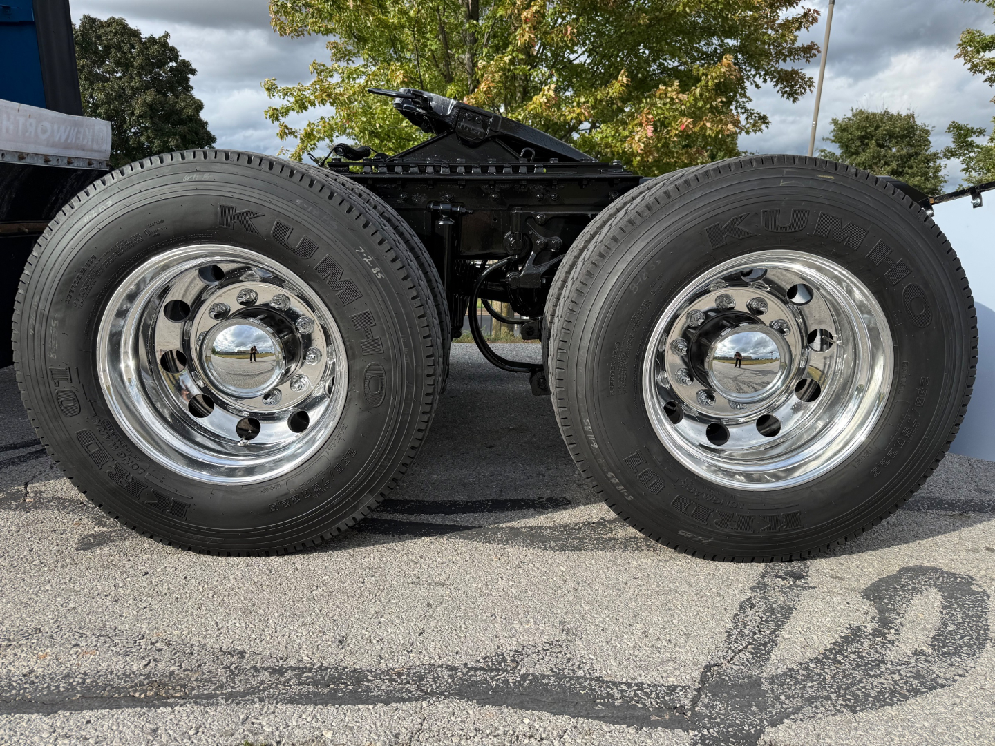 Kenworth T680 chassis showing dual rear dual wheels with chrome rims and tires labeled 'Dunlop' or similar, hub caps visible.