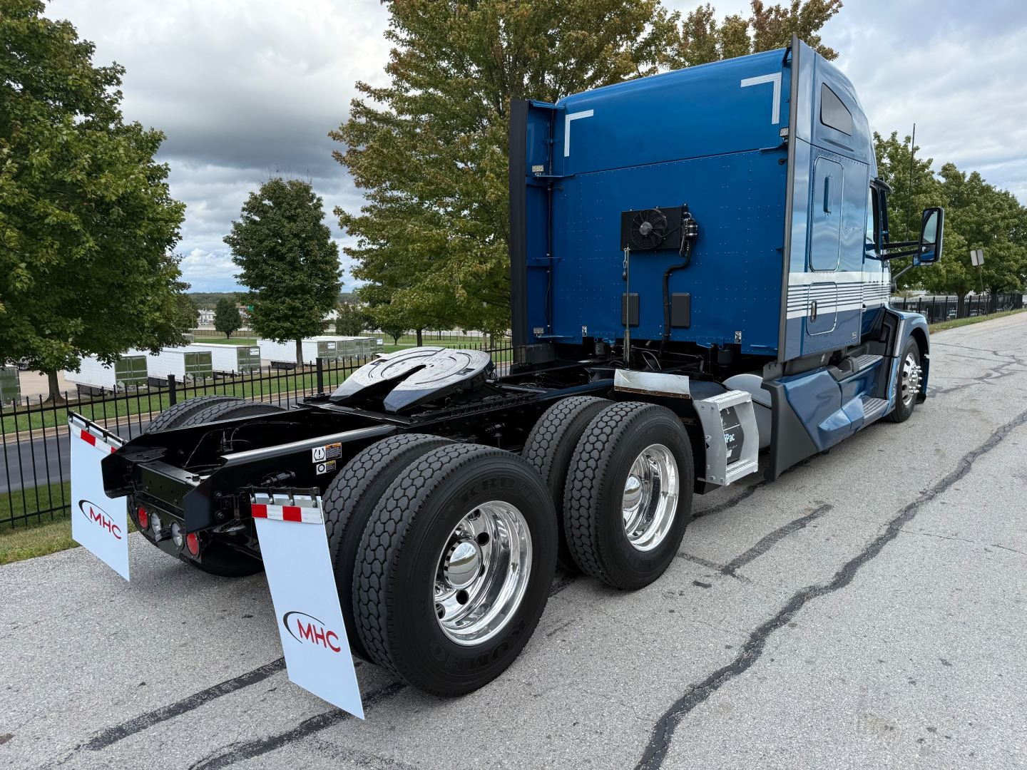 Kenworth T680 tractor rear-side view showing dual rear axles and blue sleeper cab.