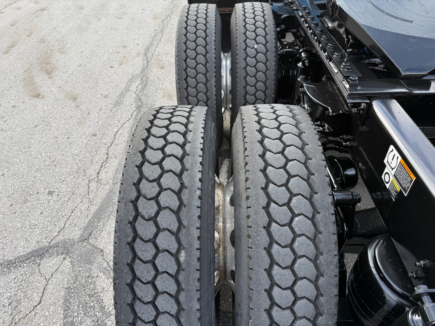 Kenworth T680 truck rear dual-axle wheels with tread pattern visible and part of chassis