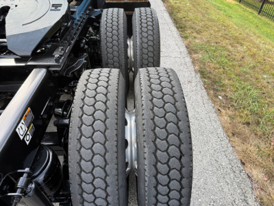Kenworth T680 wheel detail showing dual rear axles with treaded truck tires.