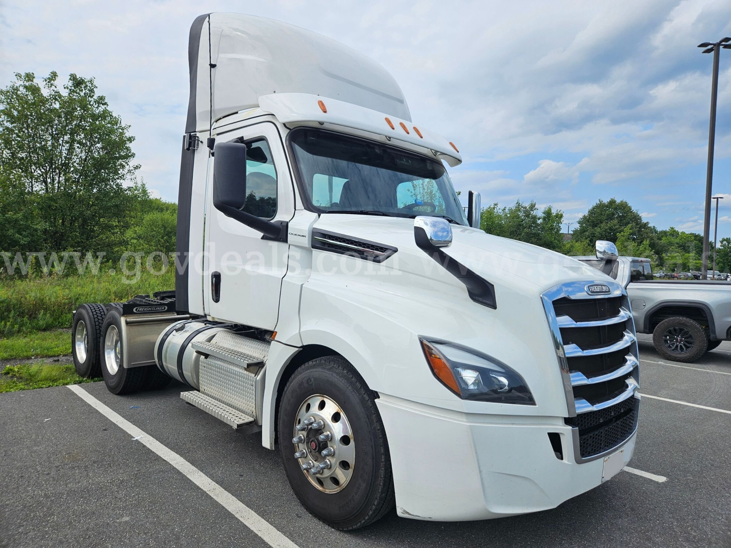 Freightliner Cascadia truck cab in white profile showing sleeper height and front grille.