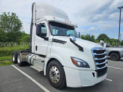 Freightliner Cascadia truck cab in white profile showing sleeper height and front grille.