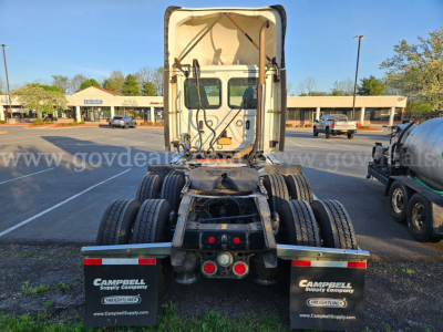 Truck chassis and cab rear view showing fifth-wheel area and dual rear axles with Campbell Supply Company mud flaps.