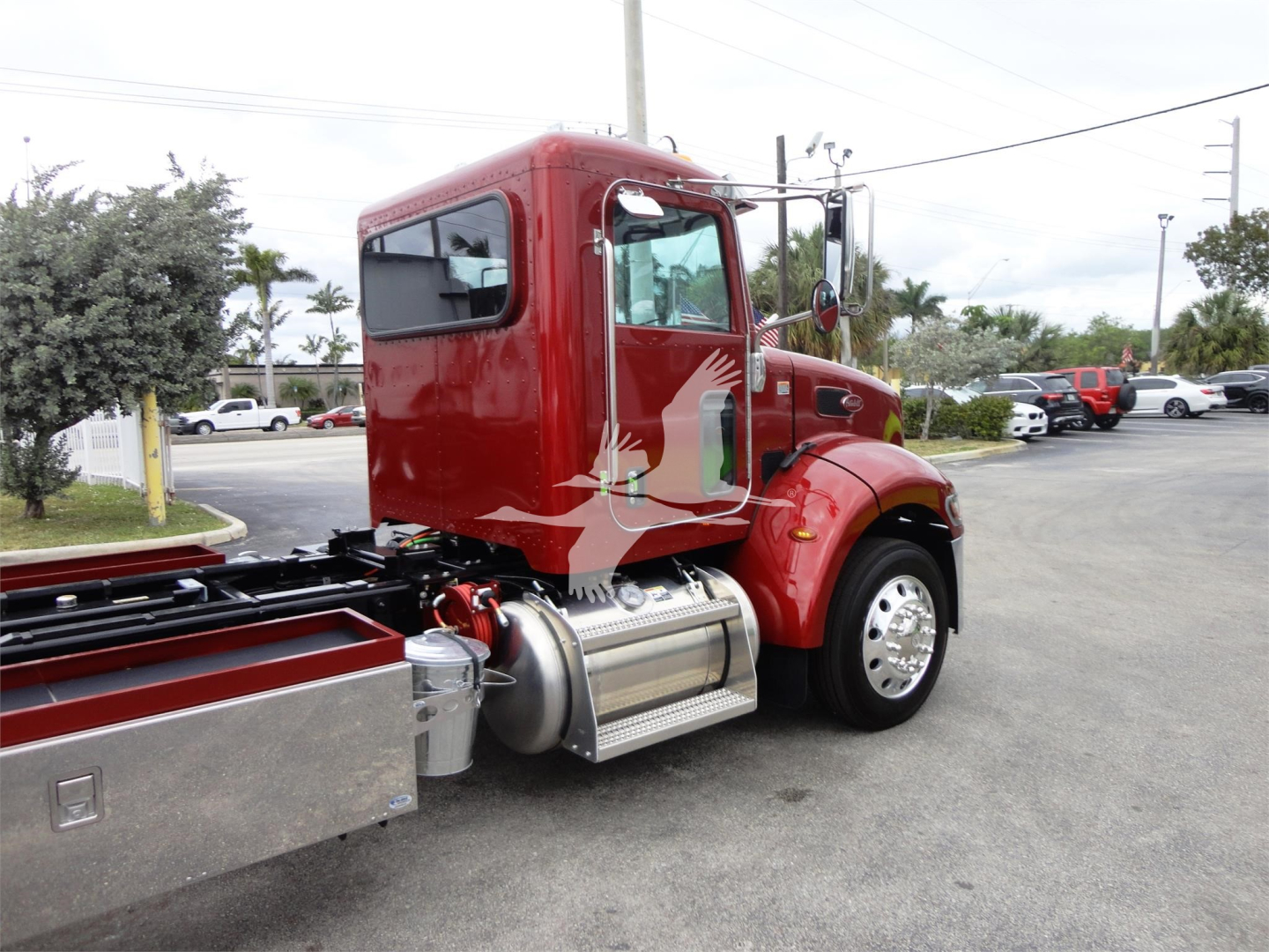 Peterbilt 337 rollback truck side cab with fuel tank and side steps, red color, visible fuel tank, exhaust, and wheel; no legible labels or numbers readable.