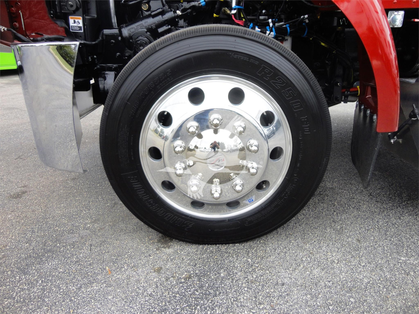 Peterbilt 337 wheel and chrome hub showing polished steel rim and tire sidewall with bolts and components in view