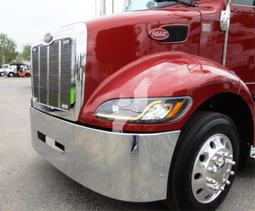 Peterbilt 337 truck front left view showing chrome grille, headlight, bumper, and front fender with Peterbilt emblem.
