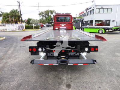 Peterbilt 337 rollback tow truck rear view showing flatbed and rear lights.