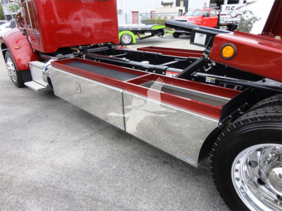 Peterbilt 337 rollback truck side view showing chrome side toolbox with reflective surface and red cab; fuel/air lines and chassis visible.