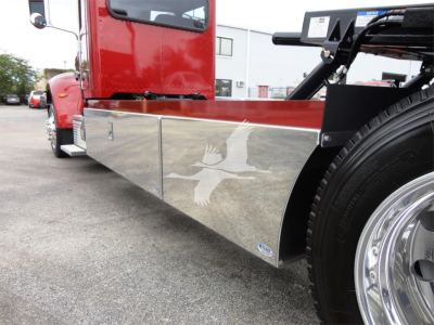 Peterbilt 337 rollback truck side view showing polished aluminum toolbox and chrome wheel, red cab with new/unused condition label.