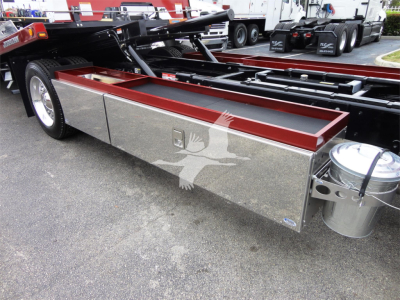 Peterbilt 337 rollback truck side toolbox aluminum storage box with maroon top edge and chrome fuel/air tanks visible
