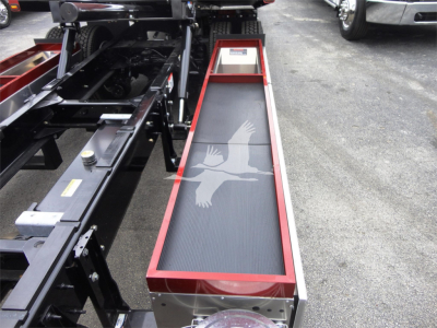Peterbilt 337 rollback truck chassis with hydraulic platform and grab handle, gray non-slip step surface with eagle logo.
