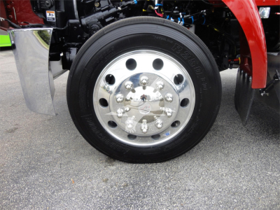 Peterbilt 337 wheel and chrome hub showing polished steel rim and tire sidewall with bolts and components in view