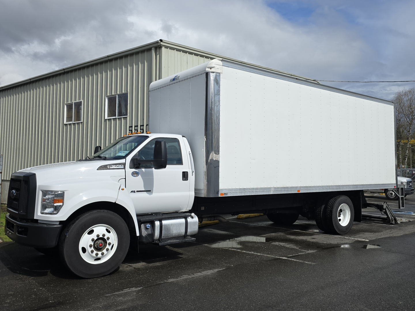 Ford 2019 F650 box truck in white, side view showing cab and large box body mounted on dual rear wheels