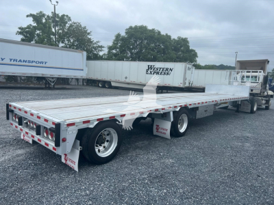 2018 Reitnouer Dropmiser flatbed trailer side and rear view showing aluminum deck and axles.