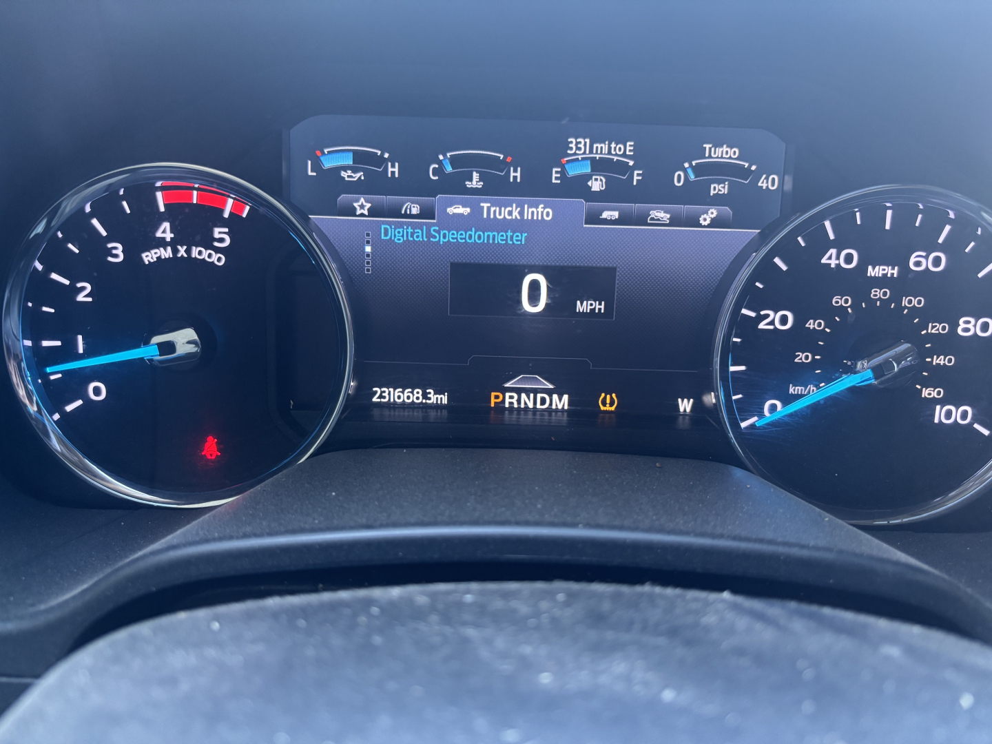 Dashboard of a 2020 Ford F350 cab and chassis showing digital speedometer at 0 mph and gauge cluster with tachometer, fuel, and engine readouts.