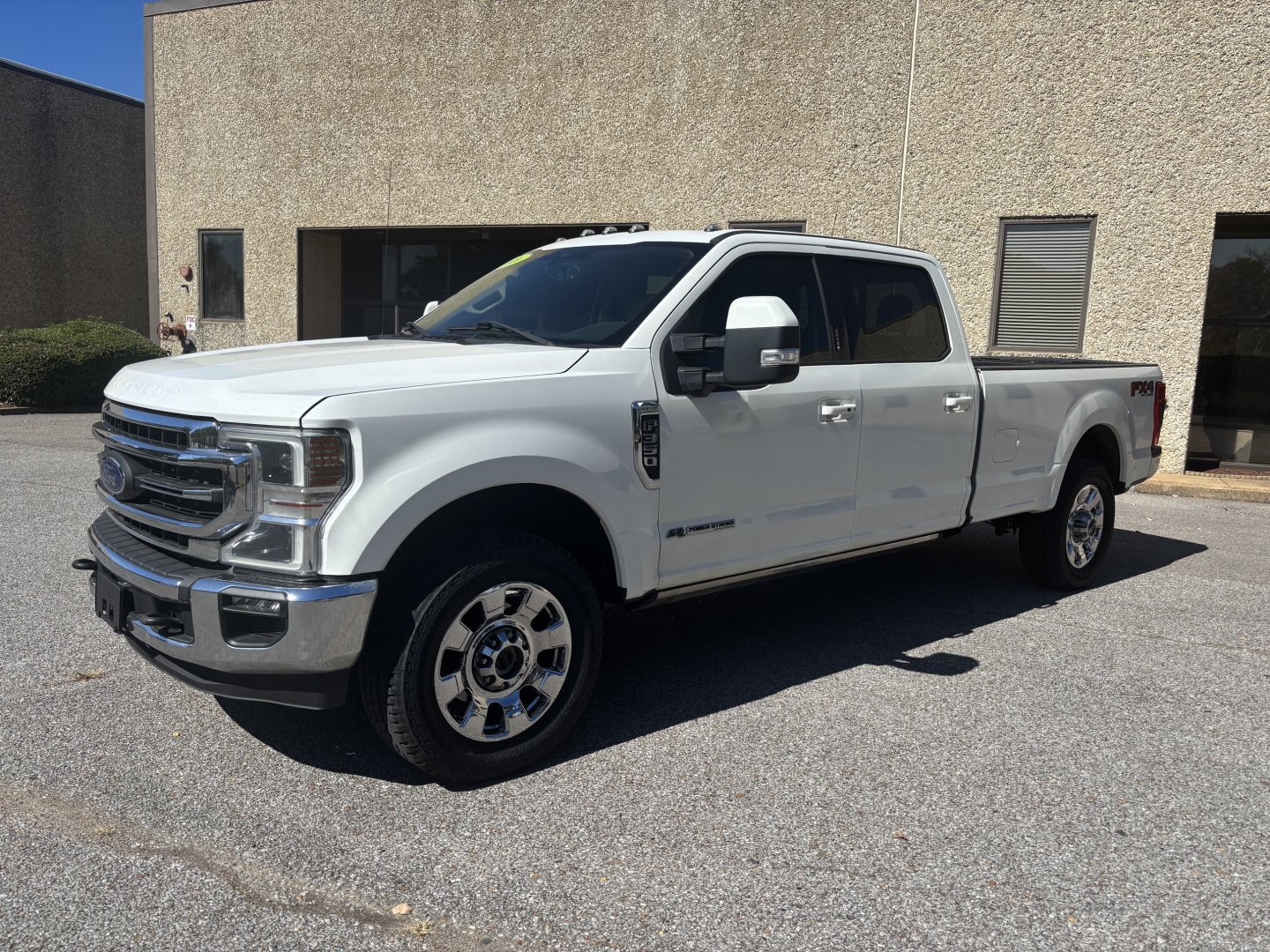 White 2020 Ford F-350 Crew Cab long bed pickup truck parked outdoors, front grille, chrome wheels, side mirrors, dual rear wheels, stock number 0633694, VIN 1FT8W3BT3LED95521.