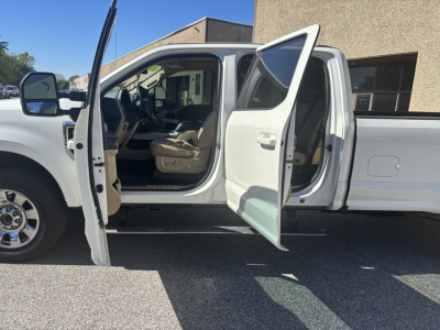 Ford F-350 Cab and Chassis side view showing front doors open and interior with beige seats.