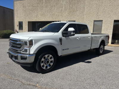 White 2020 Ford F-350 Crew Cab long bed pickup truck parked outdoors, front grille, chrome wheels, side mirrors, dual rear wheels, stock number 0633694, VIN 1FT8W3BT3LED95521.