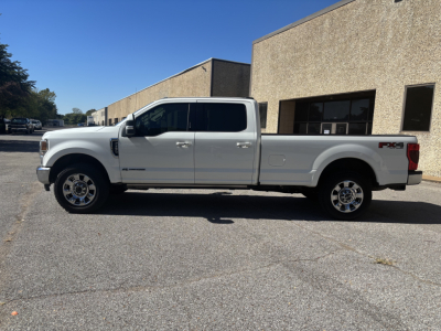 Ford F-350 Super Duty XL Crew Cab long bed pickup truck side view in a parking lot.