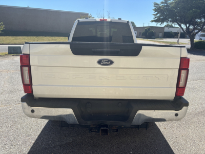 Ford F-350 Super Duty tailgate with Ford emblem and 'SUPER DUTY' lettering, rear bumper, hitch receiver visible.