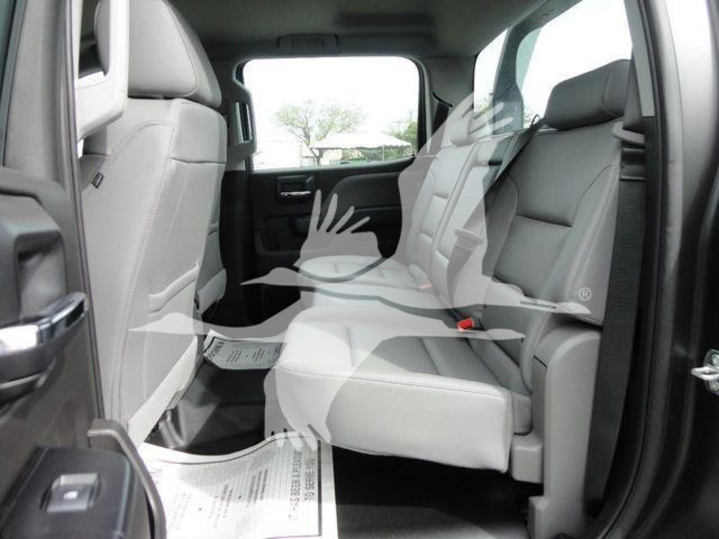 Truck back seat area of a 2023 International CV rollback truck showing light gray leather-like seats and interior paneling.