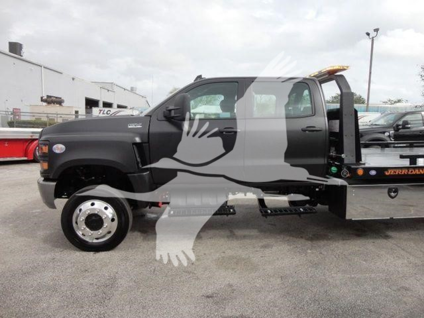2023 International CV Rollback truck in side view with cab and flatbed on a truck lot. Visible text includes J98978 stock number and rollback category label.