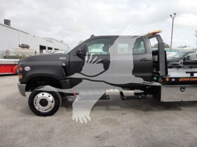 2023 International CV Rollback truck in side view with cab and flatbed on a truck lot. Visible text includes J98978 stock number and rollback category label.