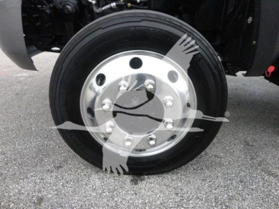Front wheel of a heavy-duty truck showing a polished aluminum hub with multiple lug nuts and a black tire.